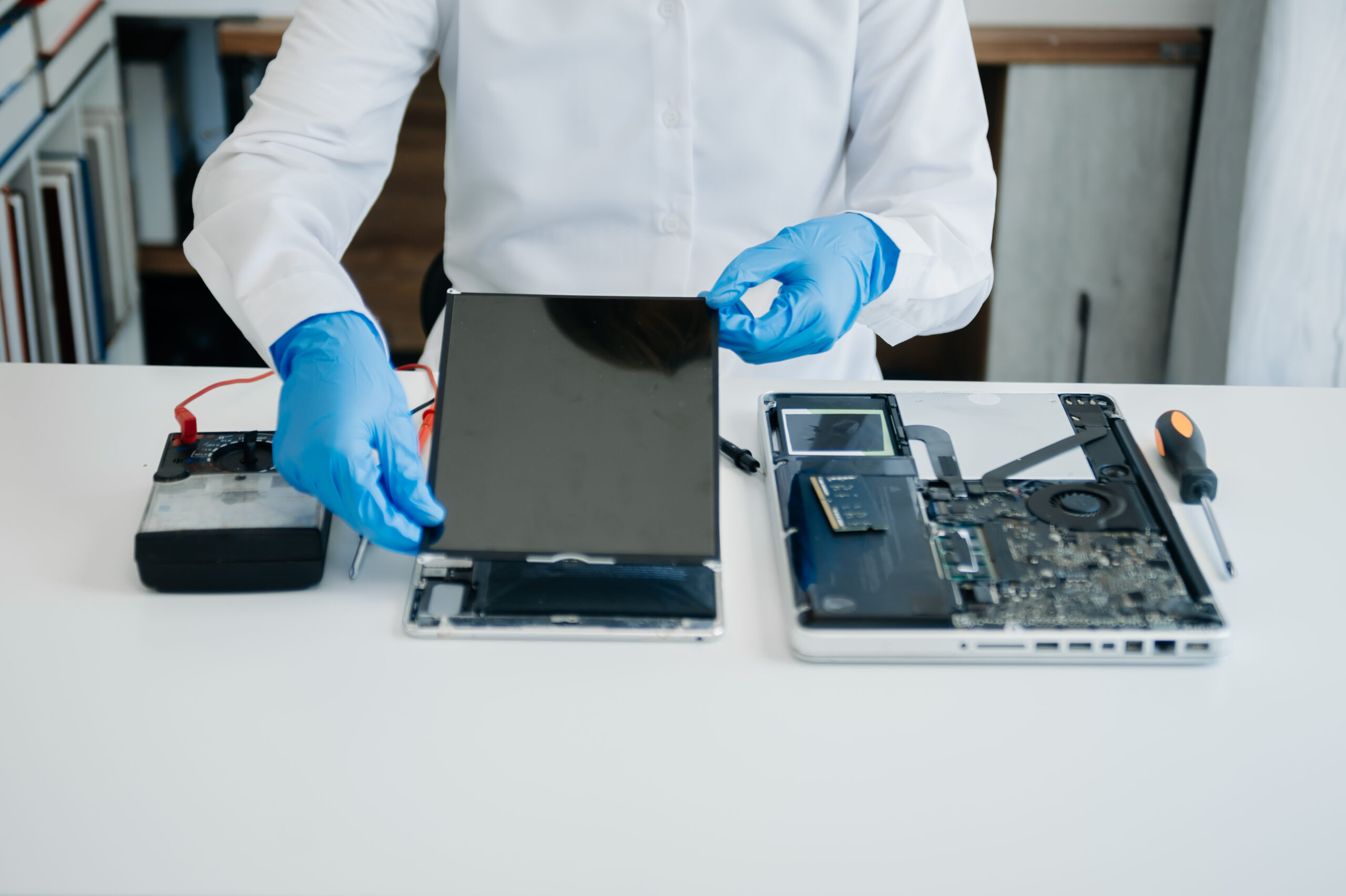 Electronics technician, electronic engineering electronic repair,electronics measuring and testing, repair and maintenance concepts.uses a voltage meter to check and upgrade
